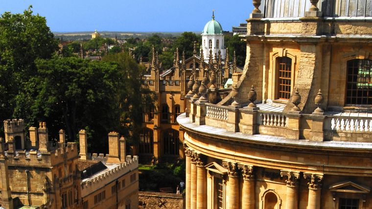 A photo of the Oxford skyline on a sunny day showing the Radcliffe Camera and surrounding buildings