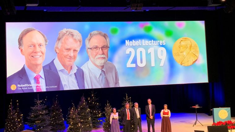 A photo from the Nobel Prize talks 2019 showing the three nominees for Medicine or Physiology on the stage.
